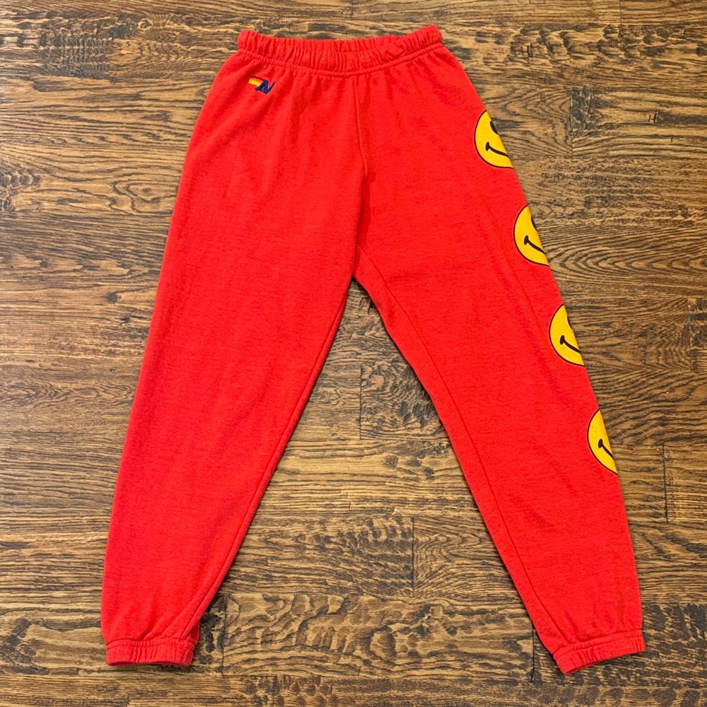 Aviator Nation Red Joggers with Yellow Smiley Design